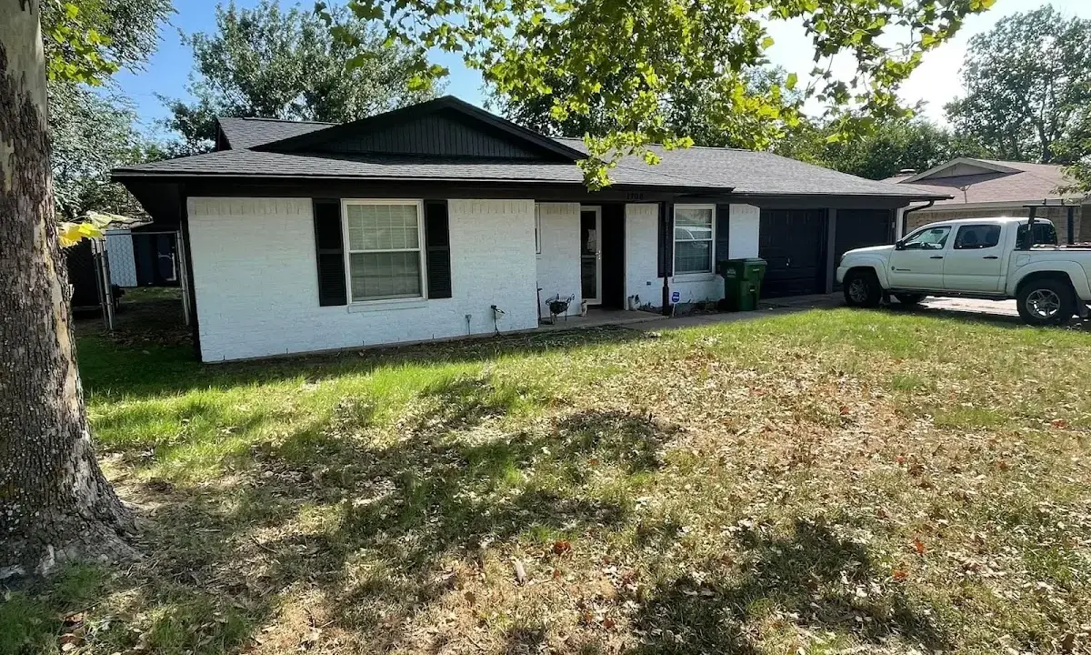 Professional roofing crew working on a residential roof in Le Ray